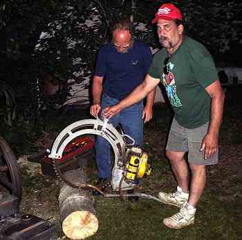 Chet keeping da saw running so Mountain Jack can cut da log
